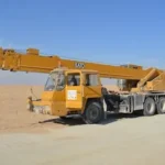 yellow and black excavator on white sand during daytime