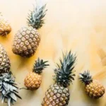 pineapples on brown surface