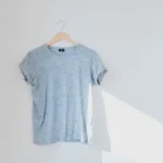 hanged grey shirt on white wall