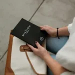 woman holding black Mission book