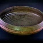 brown round ceramic bowl on black surface