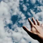 person hand reaching for the sky