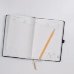 pencil on opened notebook