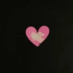 a pink heart cut out of a piece of paper