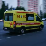 yellow and red ambulance on road during daytime