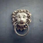 a lion's head is attached to a door handle