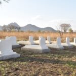 a cemetery with many white headstones