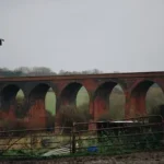 an old brick bridge with arches over it
