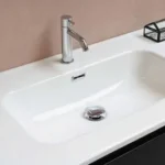 stainless steel faucet on white ceramic sink