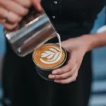 person holding coffee with latte cup
