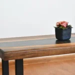 red flower on blue ceramic vase on brown wooden table