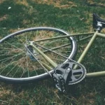 bicycle down on green grass field