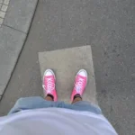 person wearing pink sneakers