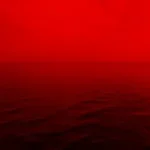 photo of ocean with red lights