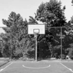 grayscale photo of basketball court