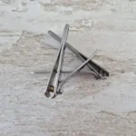 a pair of scissors sitting on top of a wooden table