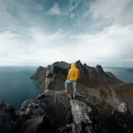 man standing on mountain peak