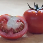 sliced tomato on brown wooden table