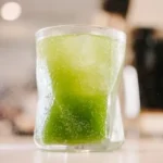 green liquid in clear drinking glass