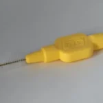 yellow plastic handle on white table