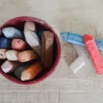 assorted-color crayons in cup