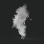 person standing near smoke with black background