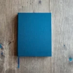 blue book on brown wooden board