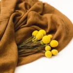 yellow flowers on brown textile