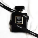 a chanel bottle with a black lanyard around it