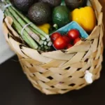 bunch of assorted produce in brown wicker basket