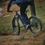 person in black jacket riding black mountain bike