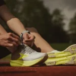 person wearing white and yellow sneakers