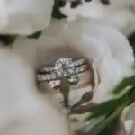 silver diamond ring on white rose