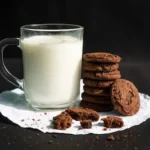 cookies and milk in clear glass mug