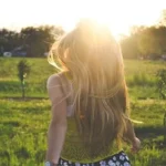 woman walking on lawn with trees