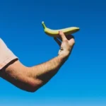 person holding green banana fruit