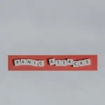 a red piece of paper with the words panic attacks spelled on it