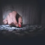 person holding red jigsaw puzzle
