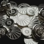 a bunch of metal buttons sitting on top of a table