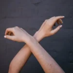 crossed person's arms
