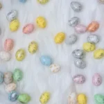 assorted-color Easter eggs on white textile