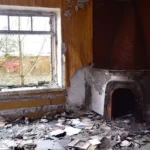 a room with a fireplace and trash