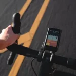 a person riding a bike with a gps app on the handlebars