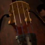 focus photography of brown and black string instrument