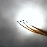 a group of jets flying through a cloudy sky