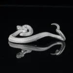 a silver snake on a black surface