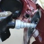 a close up of a person holding a gas pump