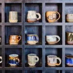 assorted-color mugs on rack
