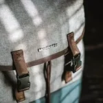 close-up photograph of gray and brown snap backpack