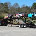 a flatbed trailer with cars on the back of it